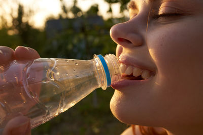 Close-up of man drinking water from bottle