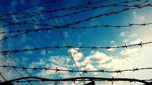 Low angle view of barbed wire against clear sky