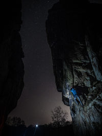Low angle view of stars on rock against sky at night