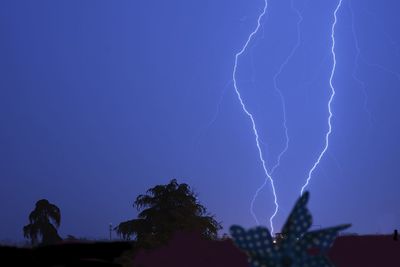 Low angle view of lightning in sky at night