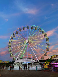 Ferris wheel in amusement park against sky