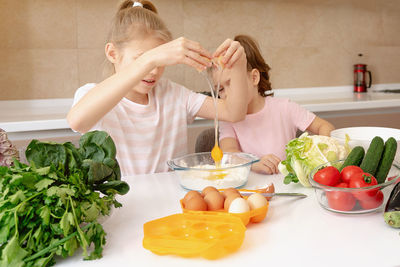 High angle view of girl having food at home