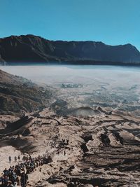 Scenic view of sea and mountains against clear sky