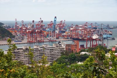 High angle view of buildings by sea against sky