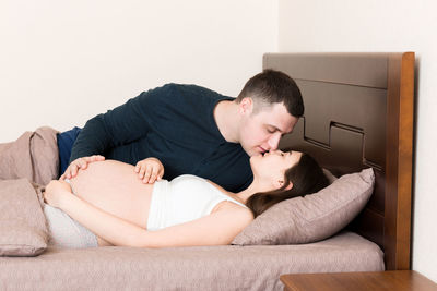 Young man lying on sofa at home