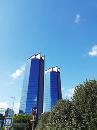 Low angle view of buildings against blue sky