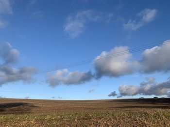 Scenic view of agricultural field against sky