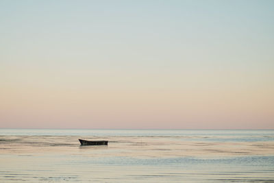 Scenic view of sea against clear sky during sunset