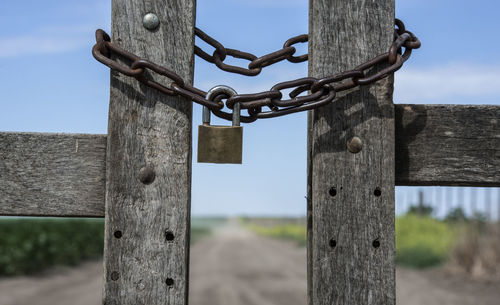 Close-up of padlock on wooden post