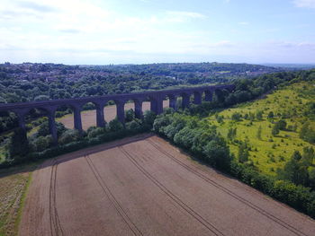 Arch bridge over river against sky