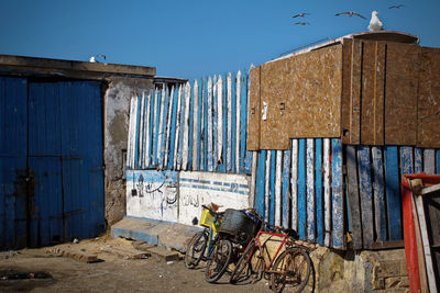 Graffiti on old building against clear blue sky