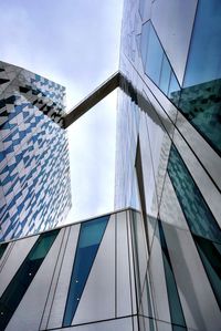 Low angle view of modern building against blue sky