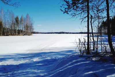 Scenic view of frozen lake against sky during winter