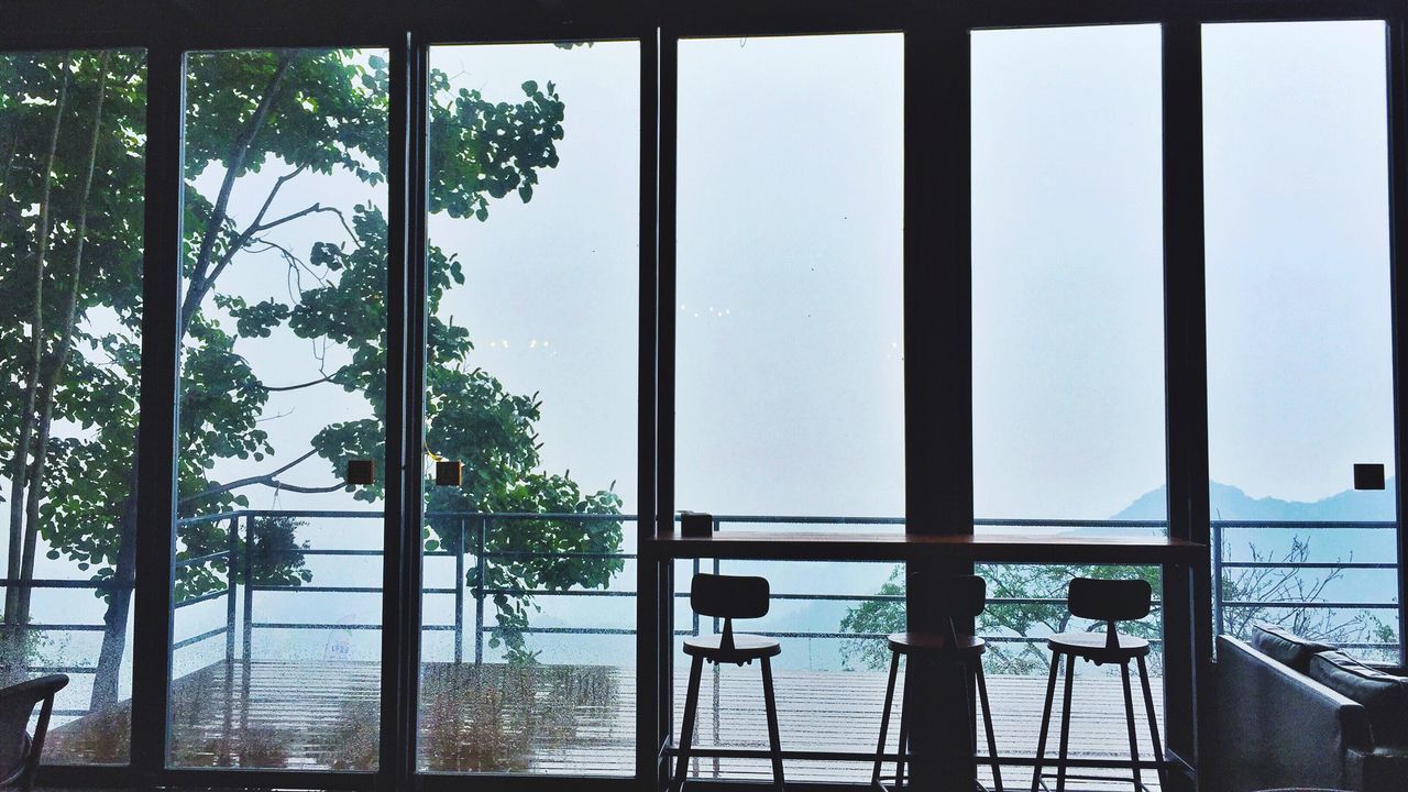 window, railing, tree, day, sea, no people, water, sky, built structure, indoors, clear sky, nature, architecture