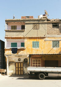 Trailer parked on street against old building