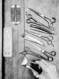 Cropped hand holding razor at barber shop