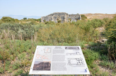 Information sign on field against clear sky