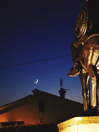 Low angle view of statue against clear sky at dusk