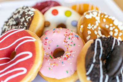 A close image of a selection of tasty donuts with different toppings 