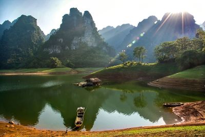 Scenic view of lake and mountains against sky