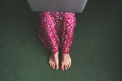 Low section of woman sitting on floor