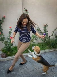 Full length of woman with daughter against plants