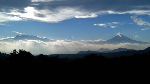 Scenic shot of silhouette mountains against sky