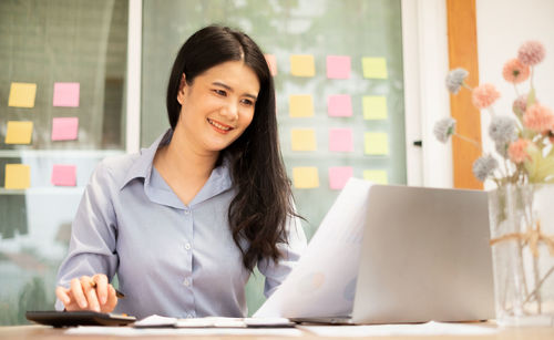 Young woman using laptop at home