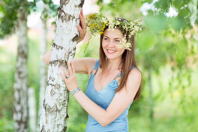 Pretty young woman with a flower wreath on her head