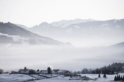 Scenic view of snow covered mountains against sky