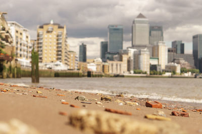 Surface level of city against cloudy sky