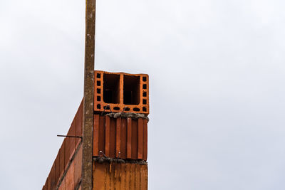 Low angle view of rusty built structure against clear sky