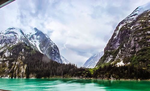 Panoramic view of frozen lake against sky