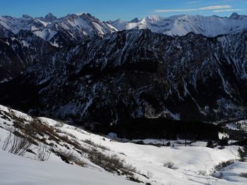 Scenic view of snow covered mountains against sky