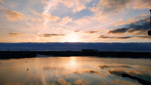 Scenic view of lake against sky during sunset