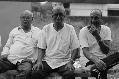 Portrait of old friends sitting outdoors