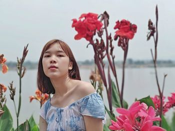 Young woman looking at flowering plants