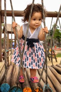 Cute girl standing on footbridge