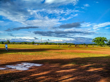 Scenic view of landscape against cloudy sky