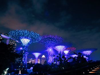 Low angle view of firework display at night