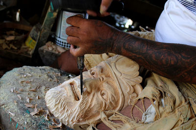 Midsection of person working on cutting board