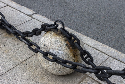 Steel black chain as a fence separating the carriageway from the pedestrian zone