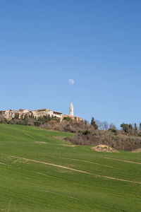 Scenic view of land against clear blue sky