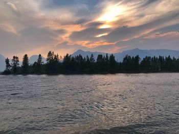 Scenic view of lake against orange sky