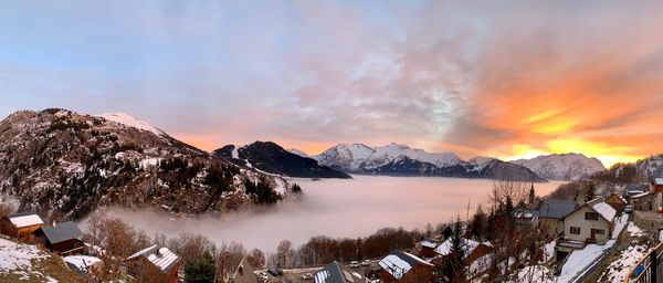 Scenic view of snowcapped mountains against sky during sunset