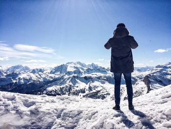 Tourist on snow covered mountain