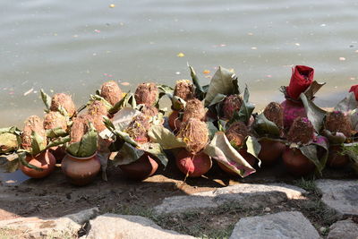 High angle view of religious offerings at riverbank