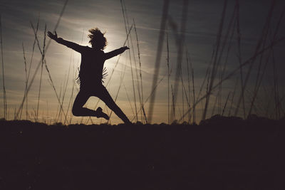 Silhouette of woman at sunset