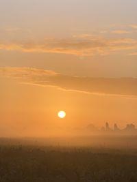 Scenic view of field against sky during sunset