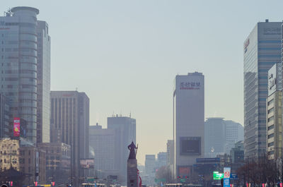 Modern buildings in city against clear sky